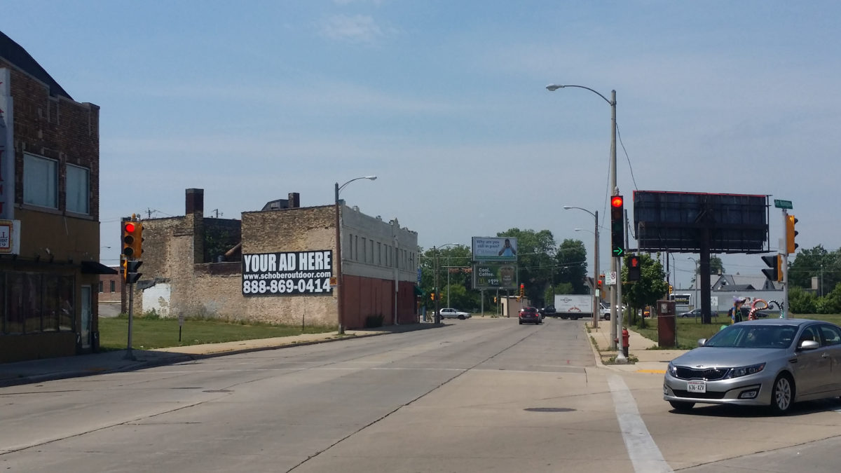 Street intersection with advertising billboard.
