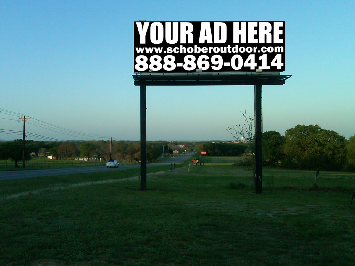 Empty billboard on roadside landscape.